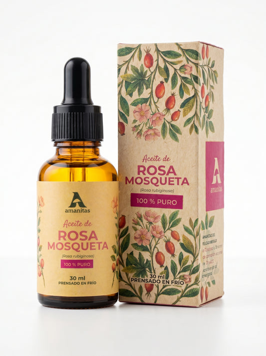 Frasco gotero de vidrio ámbar de 30 ml de Aceite de Rosa Mosqueta 100% puro y prensado en frío de Amanitas, junto a su empaque exterior con ilustraciones botánicas detalladas de la especie Rosa rubiginosa sobre fondo blanco.