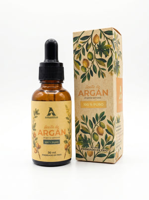 Aceite de Argán Amanitas 100% puro en frasco gotero de 30 ml junto a su empaque con diseño botánico. Producto cosmético natural premium, obtenido mediante prensado en frío, ideal para hidratación profunda y nutrición de la piel y el cabello.